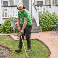 person mowing grass